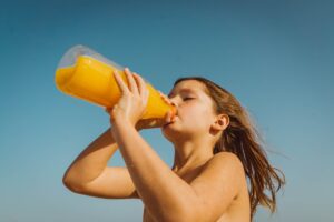 A girl drinking orange juice