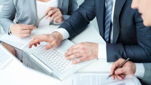 Business people working together over a laptop