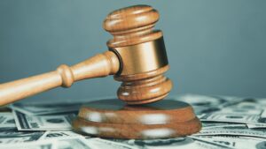 A gavel ontop of scattered dollar bills